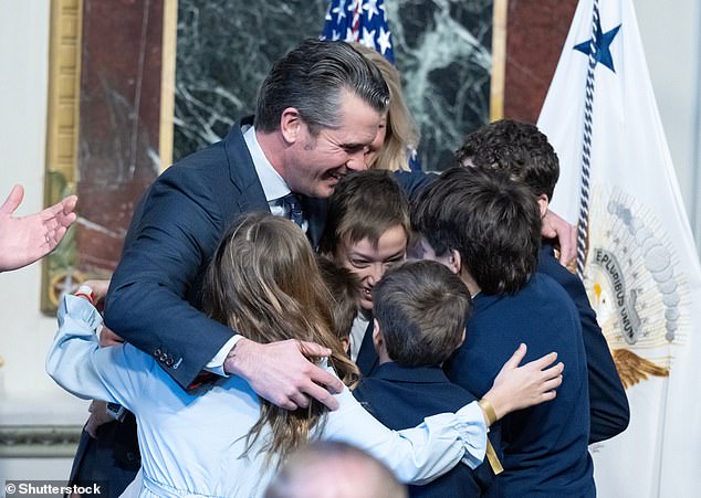 Hegseth hugs his children, after US Vice President JD Vance administered the oath of office to him