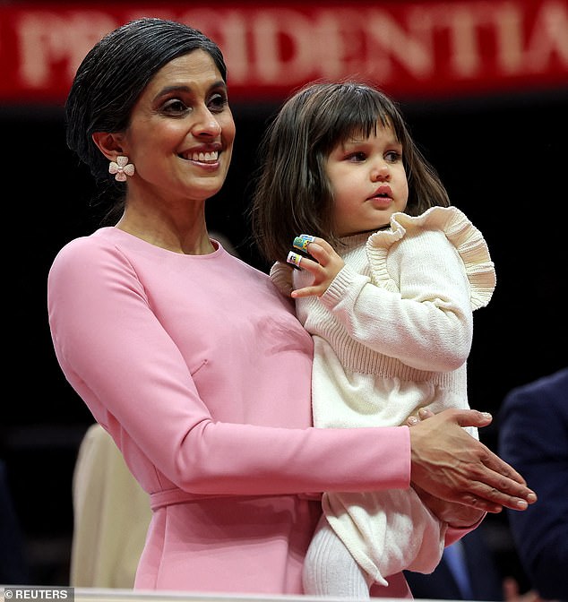 Usha holds the couple's toddler daughter Mirabel at the inaugural parade inside the Capitol One Arena