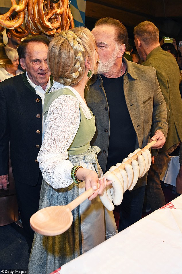 Arnold Schwarzenegger enjoyed a cheeky smooch with a woman during a visit to an Austrian ski resort on Friday