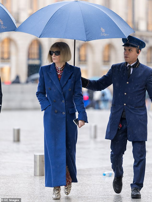 Dame Anna Wintour cut a typically stylish figure as she stepped out during Paris Fashion Week in a long blue coat on Saturday