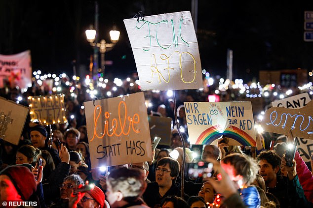 Activists take part in a demonstration entitled "We stand together! Sea of Lights Against a Shift to the Right" against the far-right Alternative for Germany (AfD) party, at the Brandenburg Gate in Berlin, Germany, January 25, 2025