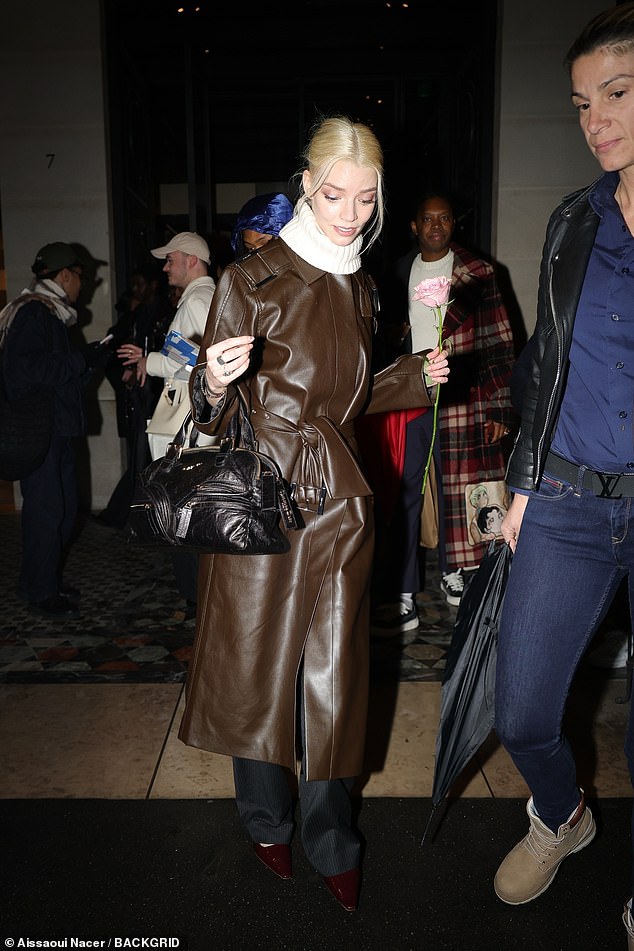 Anya Taylor-Joy clutched onto a rose as she stepped out during Paris Fashion Week on Saturday