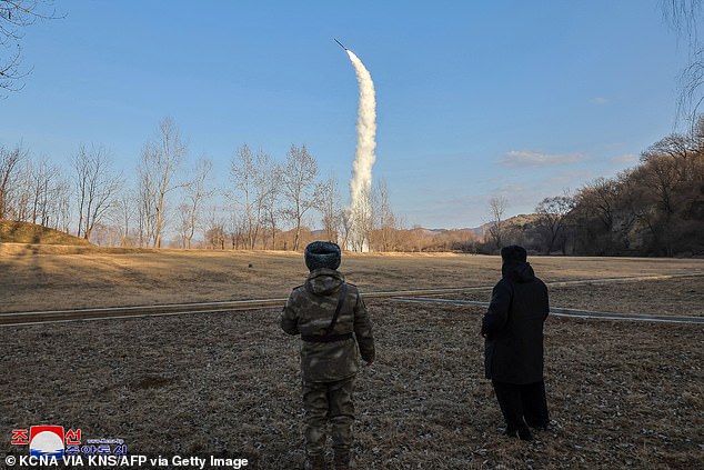 This picture taken on January 25, 2025 and released from North Korea's official Korean Central News Agency (KCNA) via KNS on January 26, 2025 shows North Korea's leader Kim Jong Un (R) overseeing the test-firing of a strategic cruise and guided weapon at sea