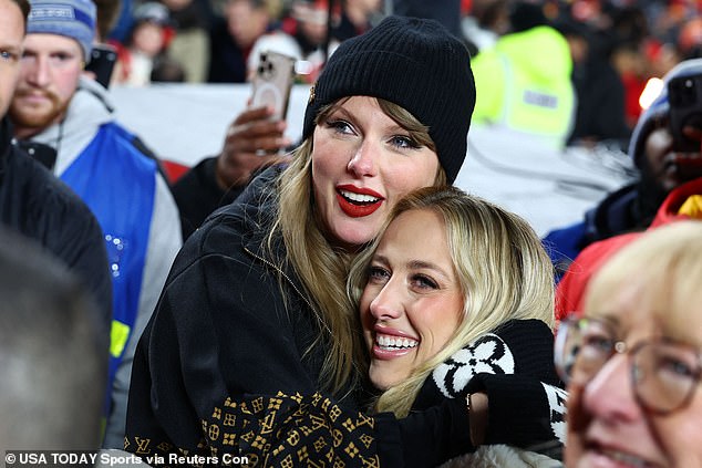 Swift hugs close friend Brittany Mahomes as they watch their loved ones get interviewed