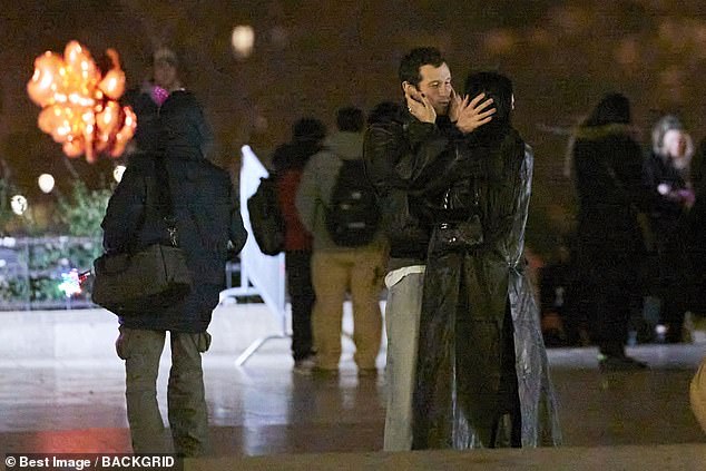 Turner and Dua hold one another's faces during their romantic after-dinner walk