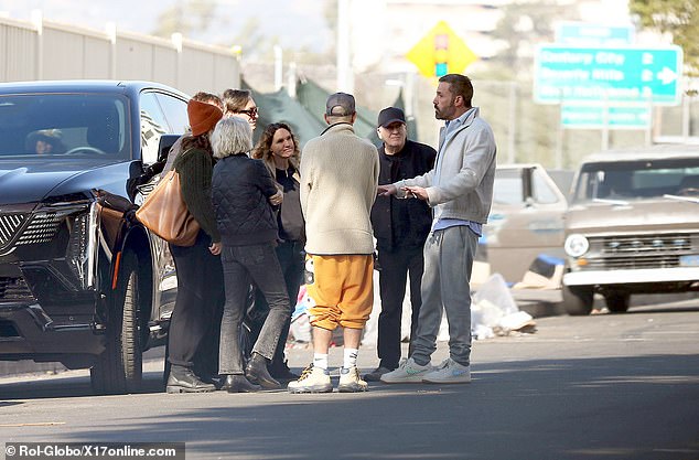 A group of volunteers were seen huddled around the father-of-three as he spoke to them just feet away from what appeared to be an encampment