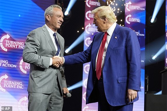 FILE - Republican presidential nominee former President Donald Trump greets Robert F. Kennedy Jr., at a Turning Point Action campaign rally, Oct. 23, 2024, in Duluth, Ga. (AP Photo/Alex Brandon)