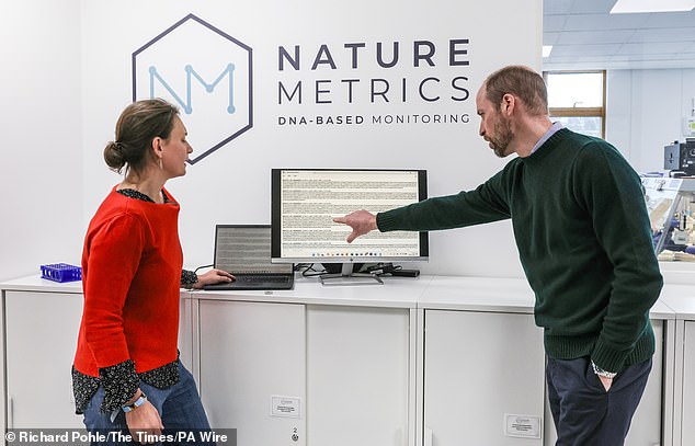 The Prince of Wales pictured with Dr Kat Bruce founder of nature metrics as they look at DNA samples extracted from areas around the world