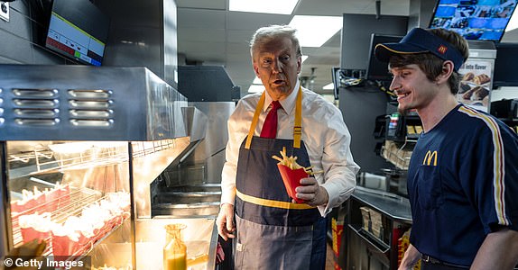 FEASTERVILLE-TREVOSE, PENNSYLVANIA - OCTOBER 20: Republican presidential nominee, former U.S. President Donald Trump works behind the counter during a campaign event at McDonald's restaurant on October 20, 2024 in Feasterville-Trevose, Pennsylvania. Trump is campaigning the entire day in the state of Pennsylvania. Trump and Democratic presidential nominee Vice President Kamala Harris continue to campaign in battleground swing states ahead of the November 5th election. (Photo by Doug Mills-Pool/Getty Images)