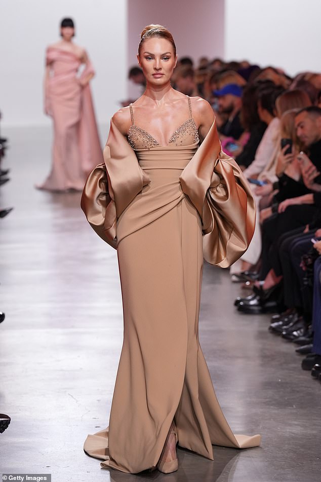 Former Victoria's Secret Angel Candice, 36, strutted down the catwalk in a figure hugging beige gown which boasted a plunging dazzling neckline and daring thigh high split