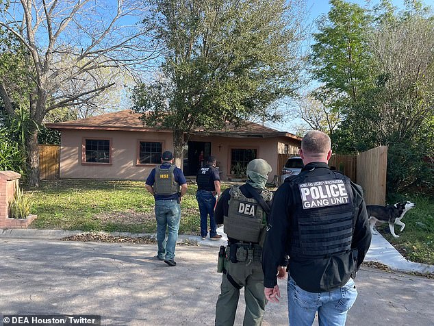 Homeland Security agents, the Houston division of the Drug Enforcement Agency and other federal agents carry out an immigration raid on Sunday