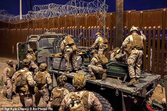 Marines with the 1st Combat Engineer Battalion, 1st Marine Division, deploy concertina wire as they re-enforce the border wall, January 25, 2025 near San Ysidro, California