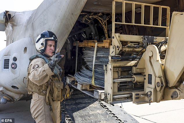 United States Marines unloading concertina wire from an MV-22B Osprey for use at the southern border at Brown Field Municipal Airport in Otay Mesa, California. They were deployed to the border area following executive orders signed by Trump last week