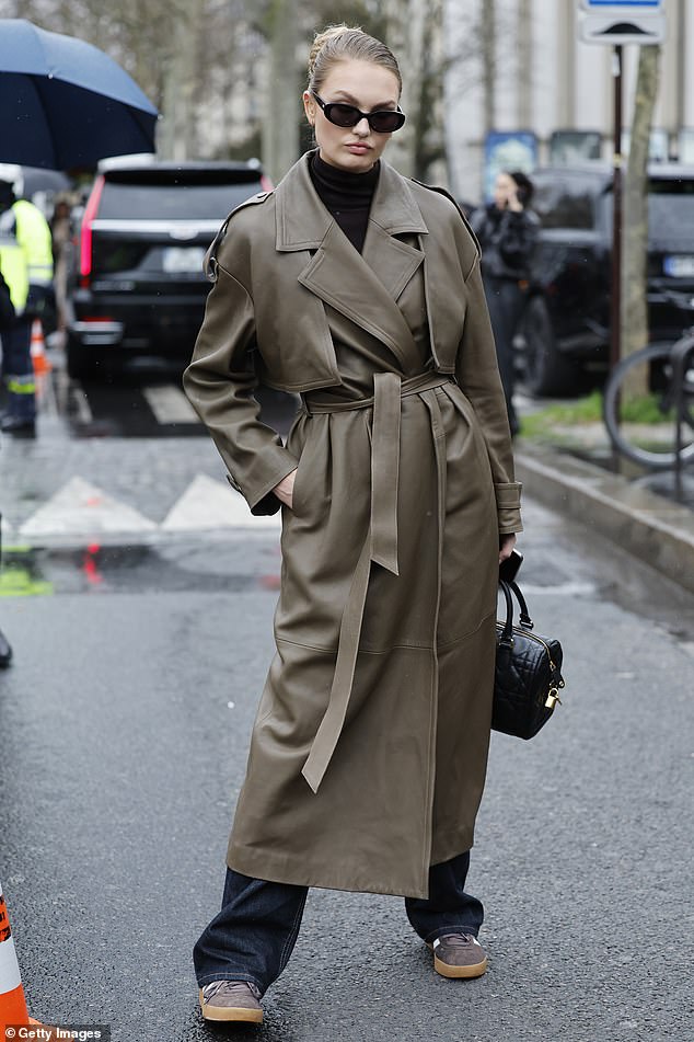 Elsewhere Romee arrived at the show wearing a khaki leather trench coat which she cinched in a the waist with a matching belt