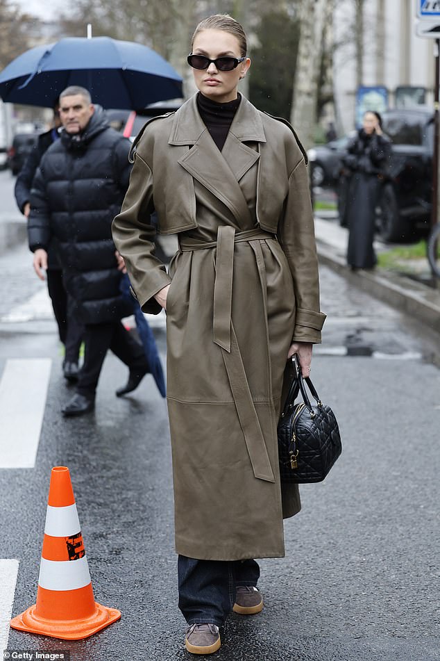 She looked effortlessly cool as she layered a brown roll neck jumper and blue denim jeans under the eye catching jacket