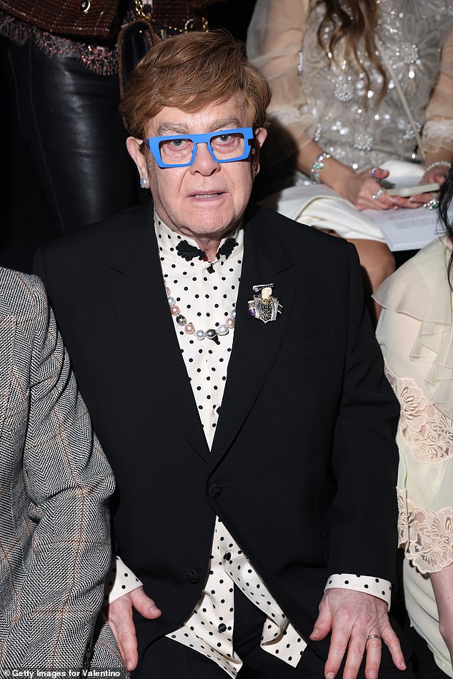 The Rocketman hitmaker, 77, wore a black and white polka dot shirt underneath a smart black blazer