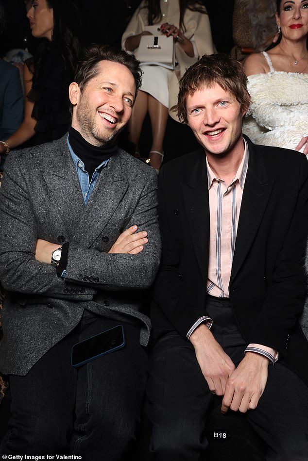 Seated next to American writer Derek Blasberg, Nikolai kept it casual in a pale pink and blue striped shirt and black blazer