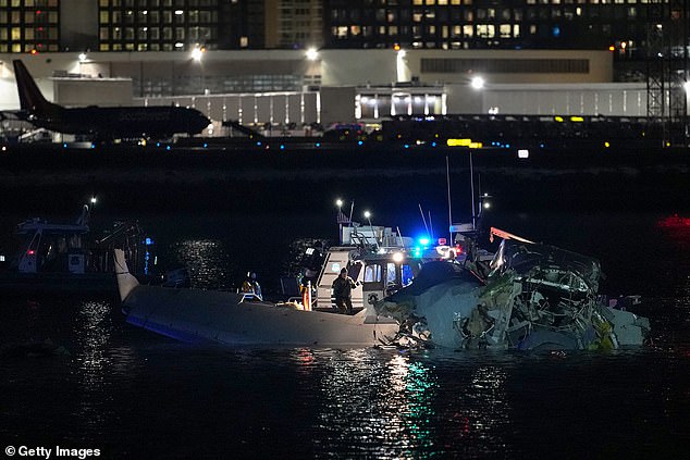 Emergency response units assess airplane wreckage in the Potomac River