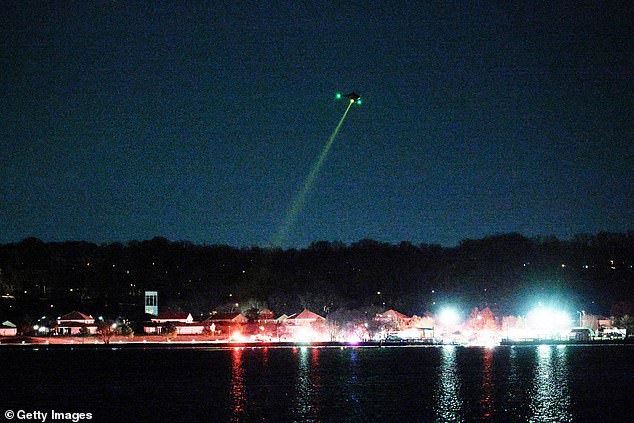 A helicopter assists with search and rescue operations over the Potomac River