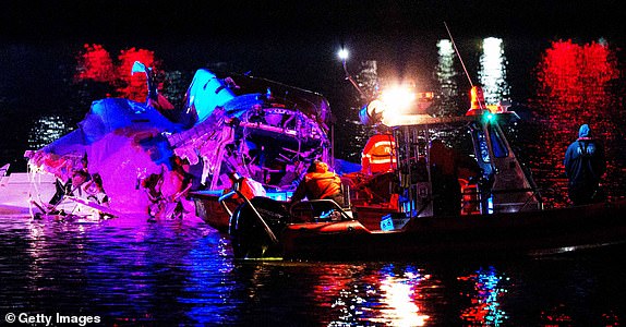 ARLINGTON, VIRGINIA - JANUARY 30: (EDITORS NOTE: Image contains graphic content) Emergency response teams including Washington, DC Fire and EMS, DC Police and others, assess airplane wreckage in the Potomac River near Ronald Reagan Washington Airport on January 30, 2025 in Arlington, Virginia. An American Airlines flight from Wichita, Kansas collided with a helicopter while approaching Ronald Reagan National Airport. (Photo by Andrew Harnik/Getty Images)