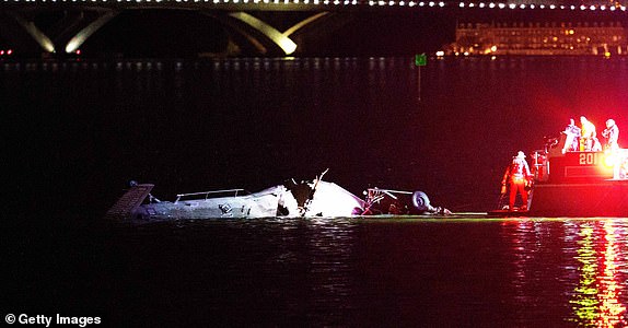 ARLINGTON, VIRGINIA - JANUARY 30: Emergency response teams including Washington, DC Fire and EMS, DC Police and others, respond to helicopter wreckage in the Potomac River near Ronald Reagan Washington Airport on January 30, 2025 in Arlington, Virginia. An American Airlines flight from Wichita, Kansas collided with a helicopter while approaching Ronald Reagan National Airport. (Photo by Andrew Harnik/Getty Images)