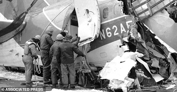 Salvage personal start to examine the tail section of the Air Florida jetliner after it was removed from the Potomac River in Washington on Monday, Jan. 18, 1982. The flight recorders were reported to be in this section of aircraft but were not found after the removal from the water. (AP Photo/Jeff Taylor)