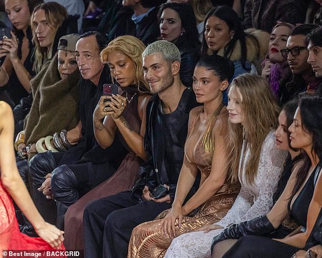 The reality star looked mesmerized by the showstopping looks on the catwalk