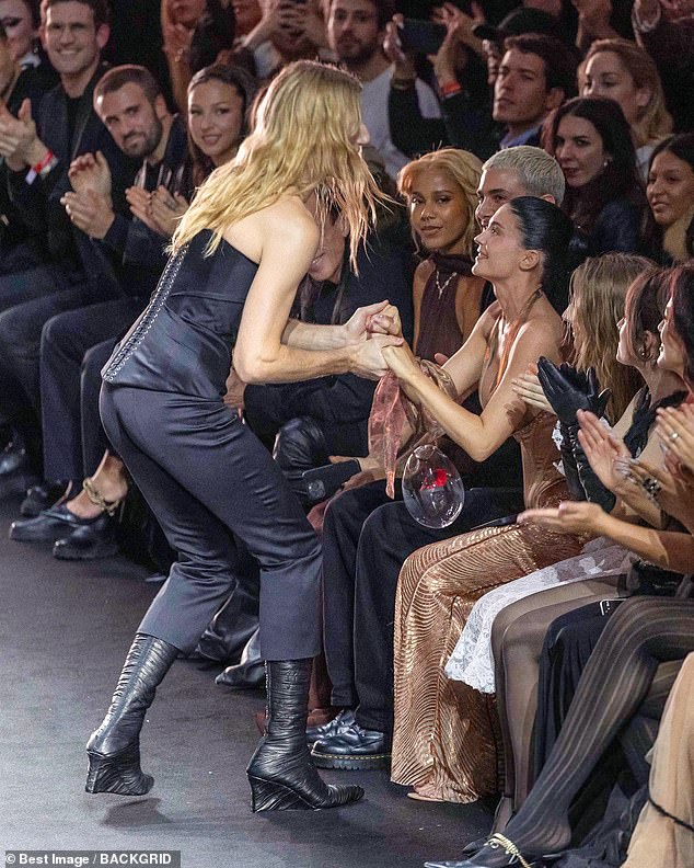 The beauty was all smiles as she held hands with Ludovic as he took a turn around the catwalk