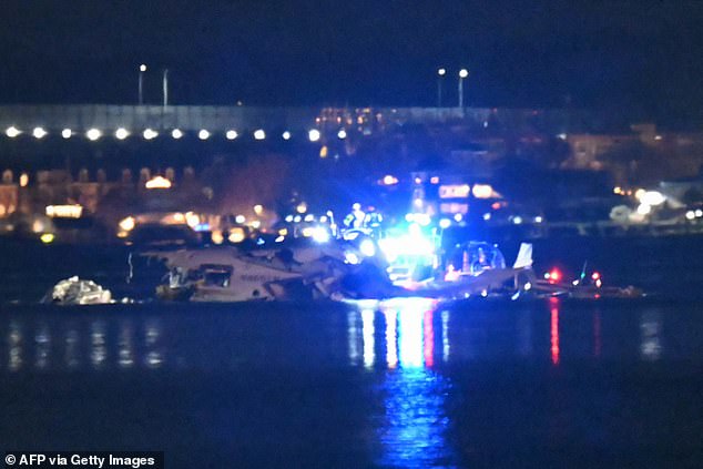 Part of the wreckage is seen as rescue boats search the waters of the Potomac River