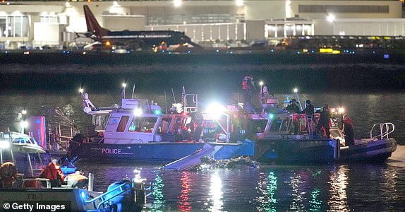 ARLINGTON, VIRGINIA - JANUARY 30: Emergency units respond after a passenger aircraft collided with a helicopter in the Potomac River near Ronald Reagan Washington Airport on January 30, 2025 in Arlington, Virginia. An American Airlines flight from Wichita, Kansas collided with an Army helicopter while approaching Ronald Reagan National Airport. (Photo by Andrew Harnik/Getty Images)