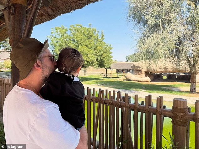 Fans got to see the youngster in his father's arms, peering into an animal enclosure