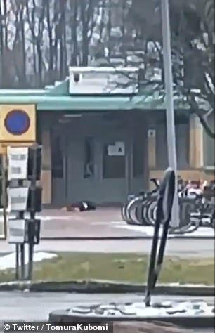 A body is seen lying outside a building