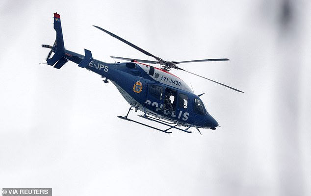 A police helicopter flies as a major police operation is underway at Risbergska School, following reports of a serious violent crime, in Orebro, Sweden, February 4, 2025