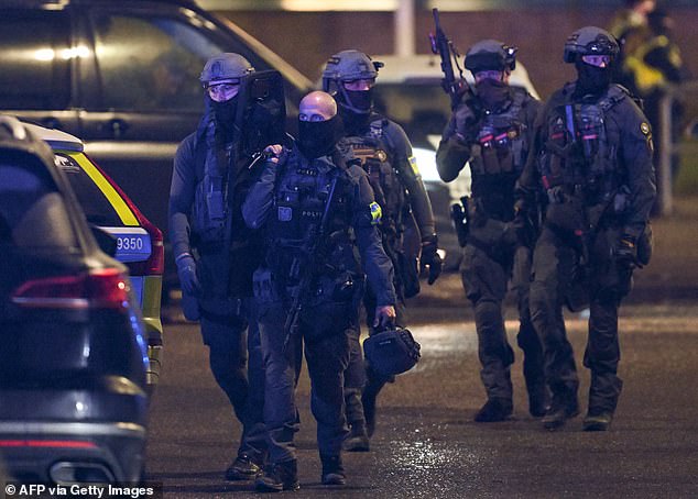 Police special forces are seen leaving the scene of the Risbergska School in Orebro, Sweden