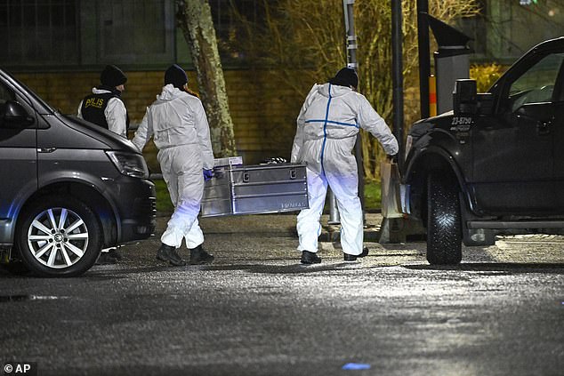 Forensic investigators are seen at the scene of a shooting overnight