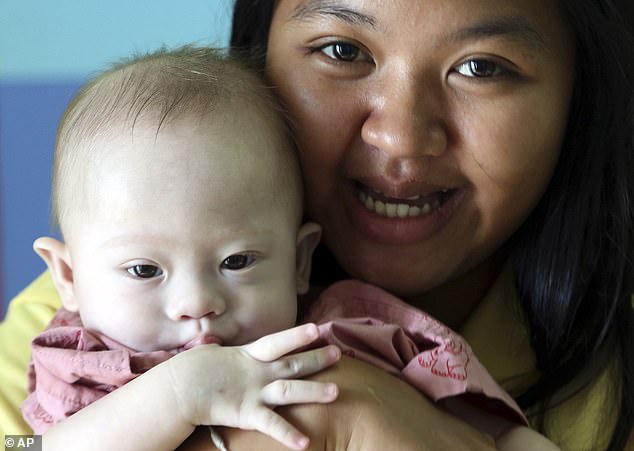 The little boy with Down Syndrome lives with his birth mother, Pattaramon Chanbua, and attends school thanks to the support of an Australian charity