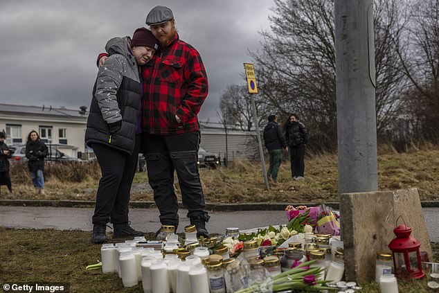 Mourners gather at the site to pay tribute to the victims on February 5, 2025 in Orebro, Sweden