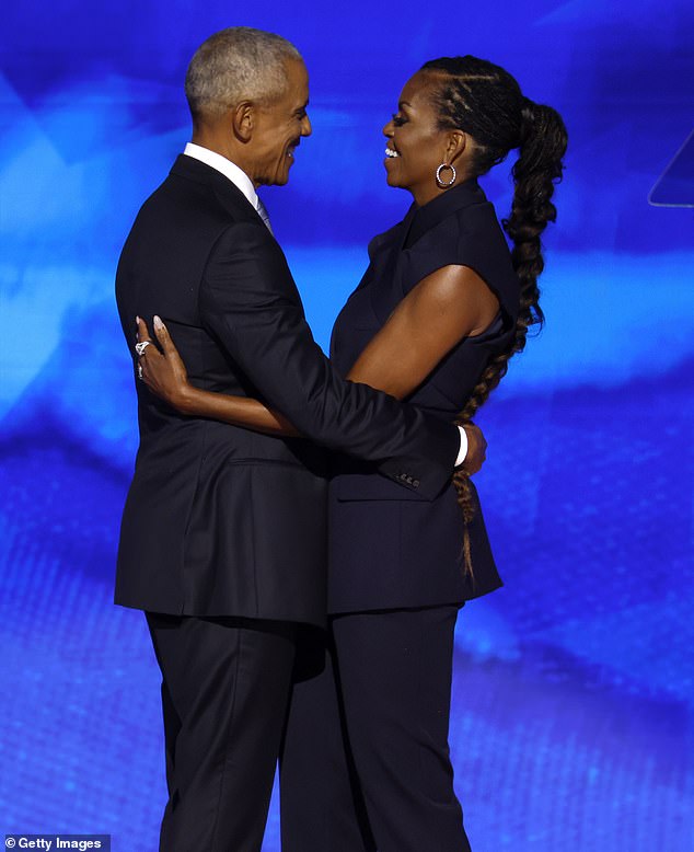 The couple, pictured at the Democratic National Convention in August, have been besieged by divorce rumors since Obama attended former president Jimmy Carter's funeral alone