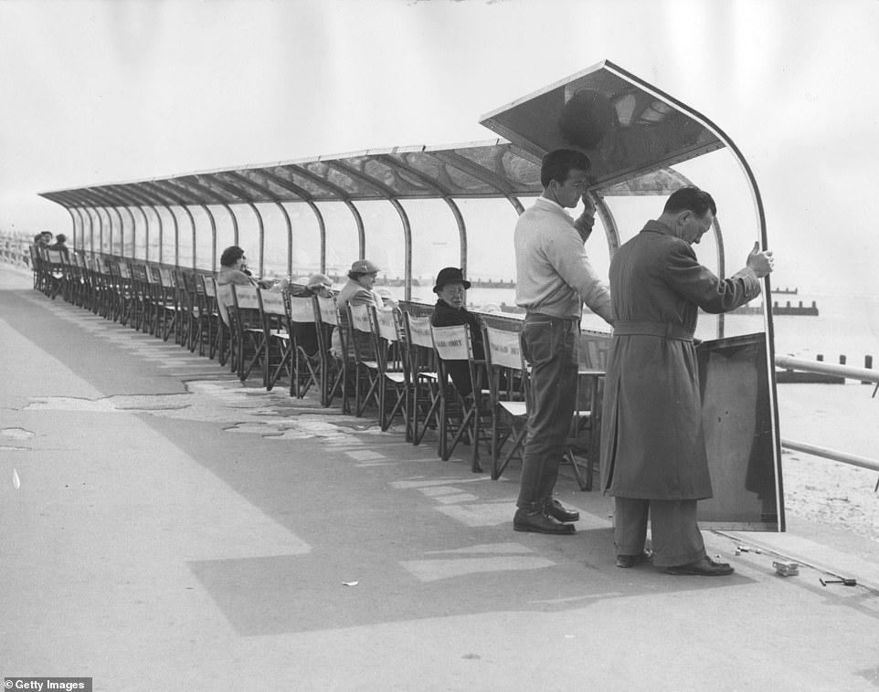 In this image, taken in 1956, Perspex windscreens are positioned on the Bognor Regis seafront as part of an experiment to 'protect holidaymakers from sea breezes'