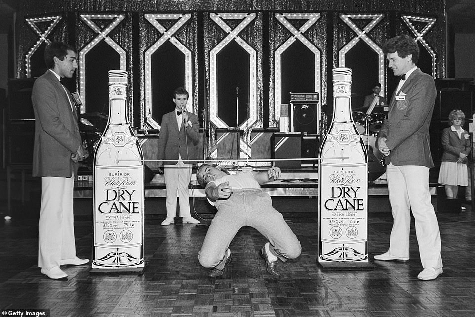 A holidaymaker competes in a limbo competition at Butlin's holiday camp in 1985. Bognor Regis is still one of the UK's most popular Butlin's camps and recently opened a new indoor playground