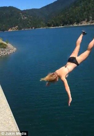 The girl was only wearing a bikini and a pair of trainers as she attempted the massive jump