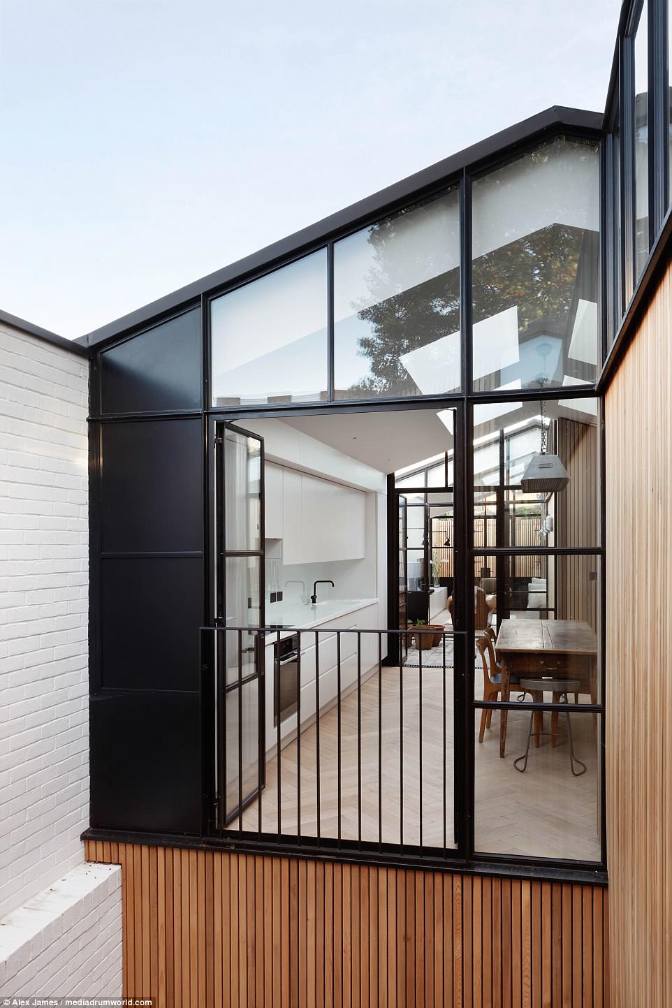 The 1076-square-foot finished property with courtyards and large glass doors allowing plenty of natural light to flood the interior