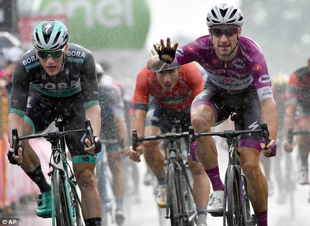 Elia Viviani (right) claimed his fourth stage win of the race following a damp sprint finish