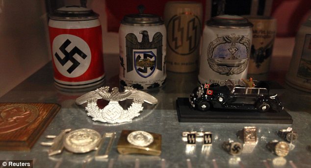 Beer mugs with swastikas and SS cuff-links show the extent of how the party's influence reached in everyday life