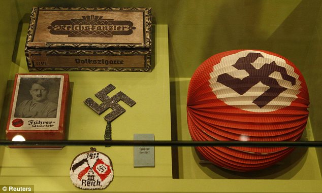 A cigar case, a Fuehrer pack of cards (left) and even a party decoration with a swastika. The exhibition shows how Nazi images filtered into every aspect of German society