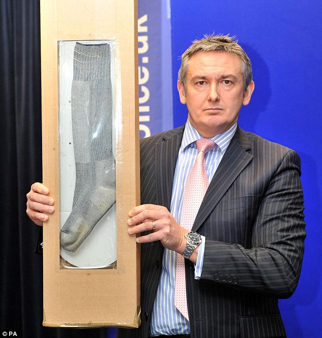 DCI Phil Jones shows a grey ski sock similar to the one found on Jo Yeates's body. Officers have revealed she was recovered wearing no shoes and a single sock - and they are keen to trace the missing one