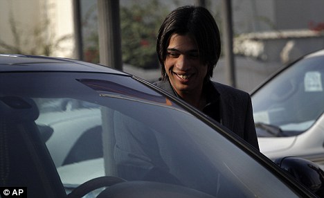 All smiles: Mohammad Amir arrives at the hearing in Doha