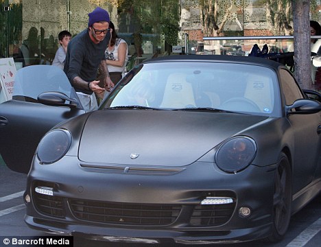 Former ride: Beckham taking the car out for a spin in September 2010