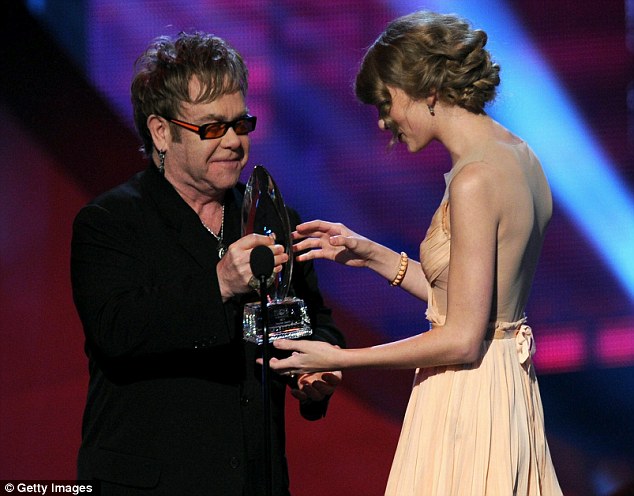 Thumbs up: Elton John presented a smiling Swift with her trophy onstage at the Nokia Theater