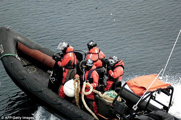 Protest: Activists hold ropes as they approach one of the Japanese ships to throw them at the propellers